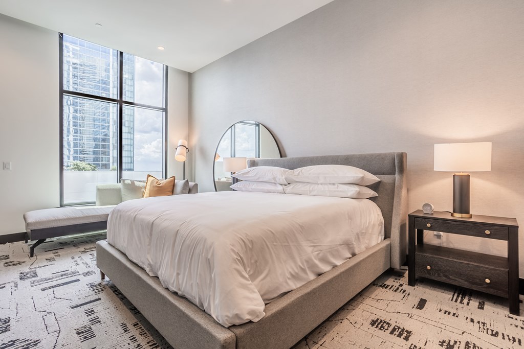 a bedroom with a large bed and a large window