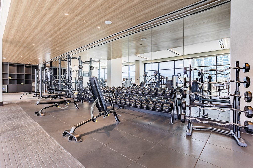 a gym with a lot of weights and cardio equipment