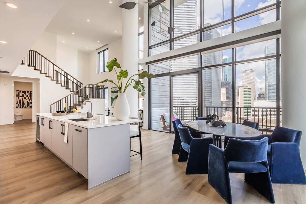 a kitchen and dining area with a large window and a table and chairs