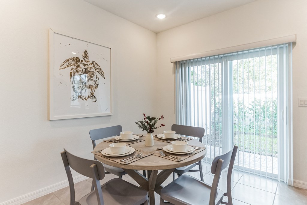 Boatman Hammock Townhomes in Lake Worth, FL photo of a dining room with a table and chairs and a window