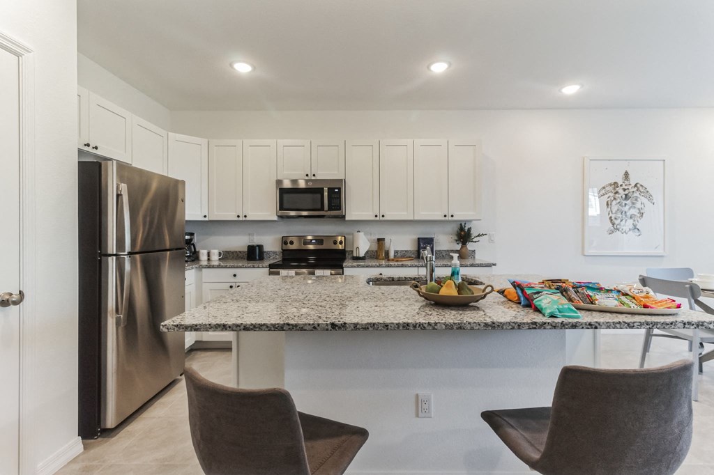 Boatman Hammock Townhomes in Lake Worth, FL photo of a kitchen with stainless steel appliances and a granite counter top
