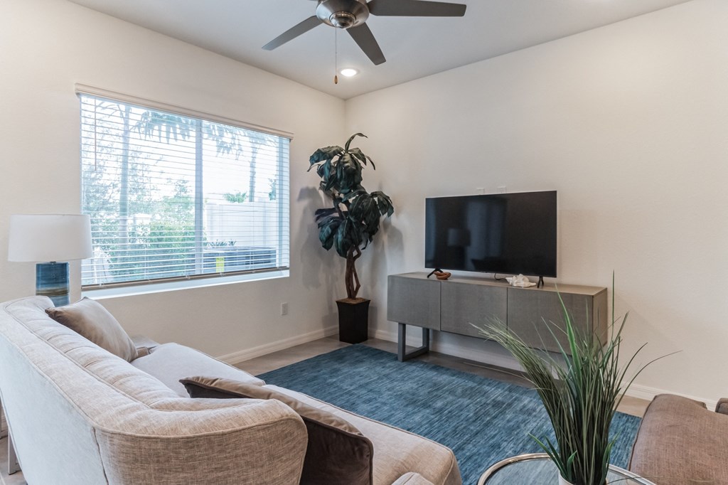 Boatman Hammock Townhomes in Lake Worth, FL photo of the living room of an apartment with a couch and a tv
