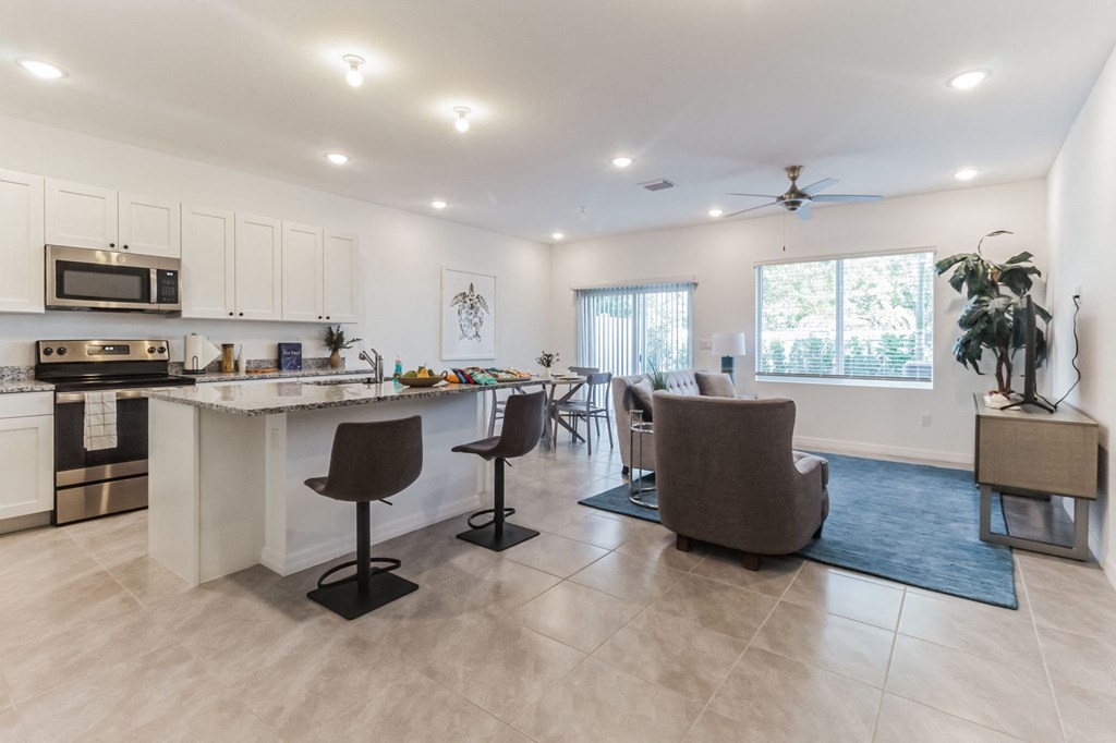 Boatman Hammock Townhomes in Lake Worth, FL photo of a living room with a kitchen and a dining room
