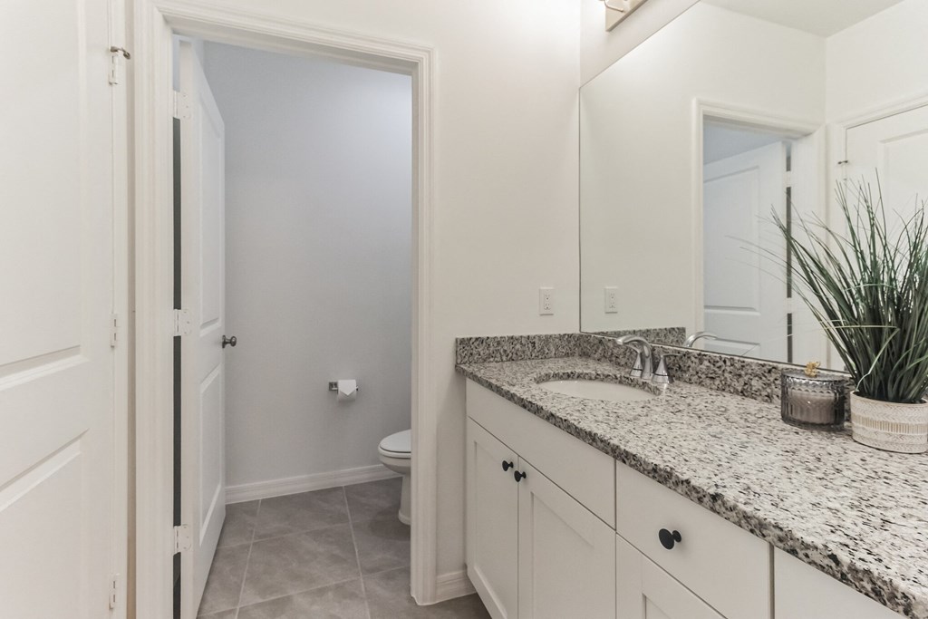 Boatman Hammock Townhomes in Lake Worth, FL photo of a bathroom with a sink and a mirror and a toilet