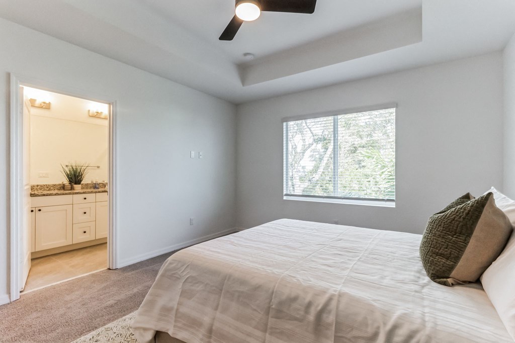 Boatman Hammock Townhomes in Lake Worth, FL photo of an empty bedroom with a large bed and a window