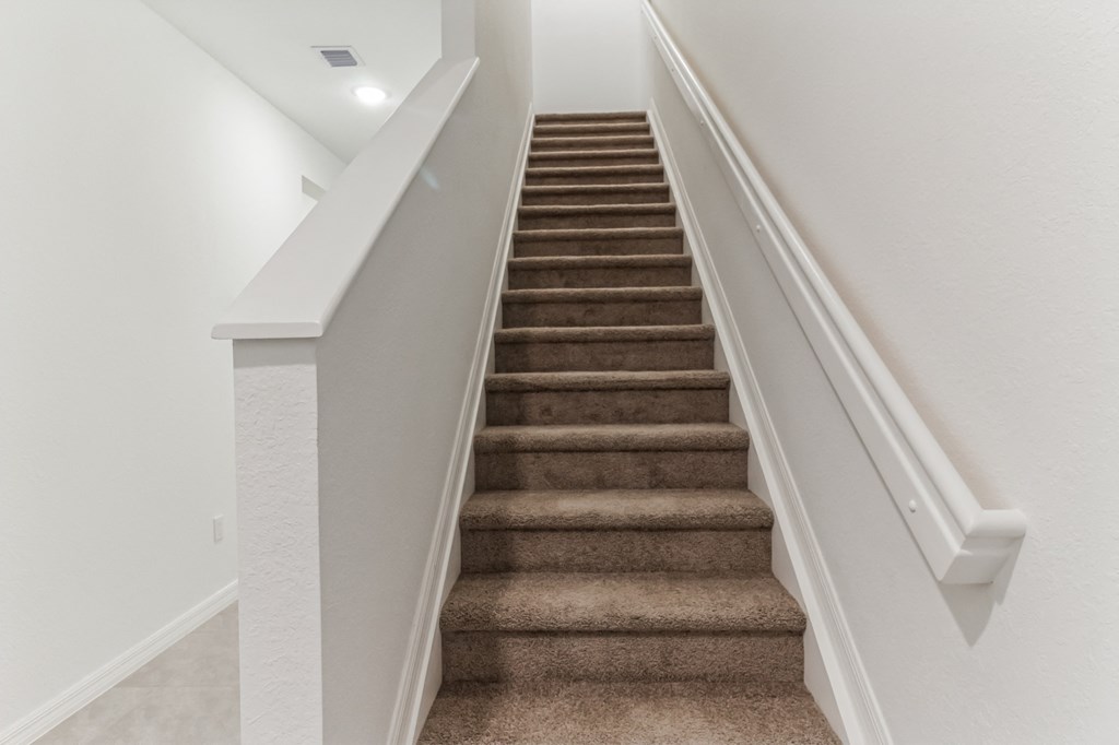 Boatman Hammock Townhomes in Lake Worth, FL photo of an image of a staircase with carpeted stairs and white railings