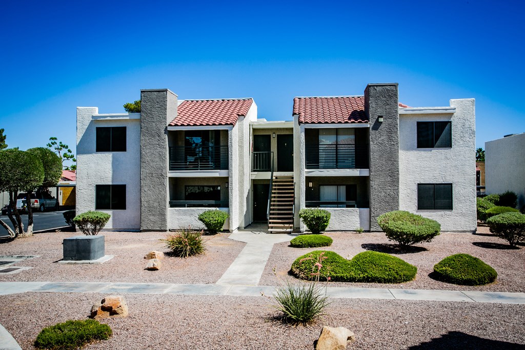 an apartment building with dogs in a courtyard