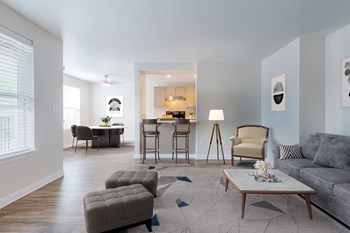 Two-Bedroom Apartments in Tigard, OR - Bull Mountain Heights - Spacious Living Room with Large Windows Leading to the Kitchen and Dining Area - Photo Gallery 2