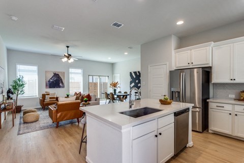 A modern kitchen with white cabinets and a large island.