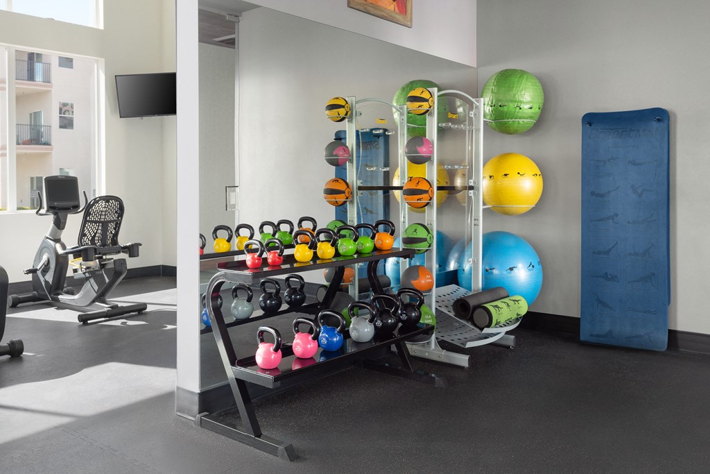 a fitness room with weights and other exercise equipment