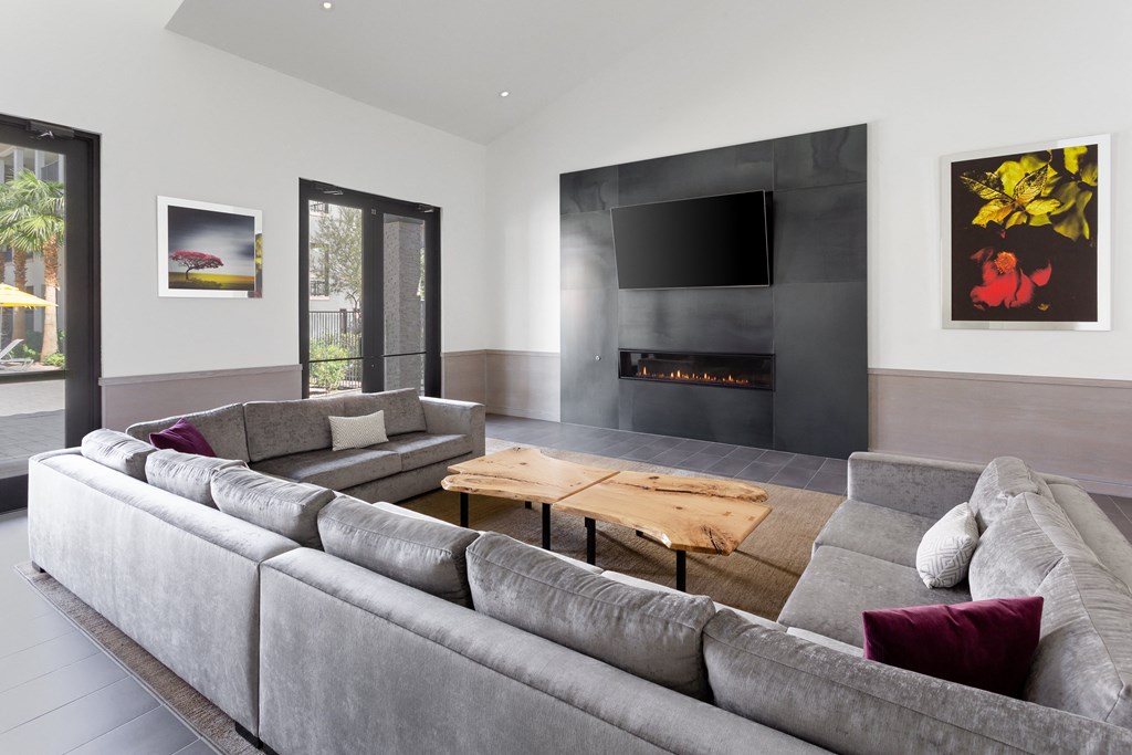 a living room with a gray couch and a wooden table