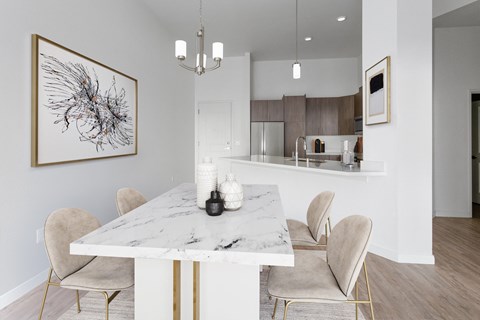 a dining room with a marble table and chairs