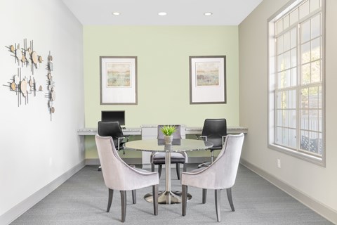 A dining room with a table and chairs.
