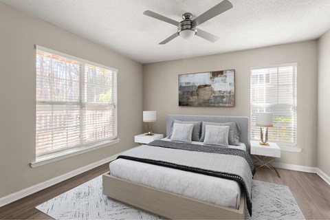 A bedroom with a bed, two lamps, and a painting on the wall.