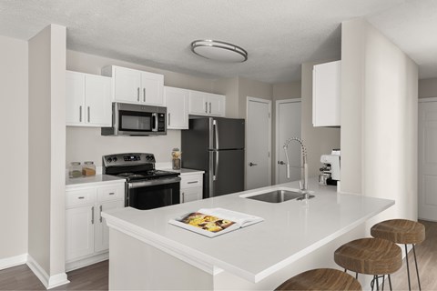 A modern kitchen with white cabinets and appliances.