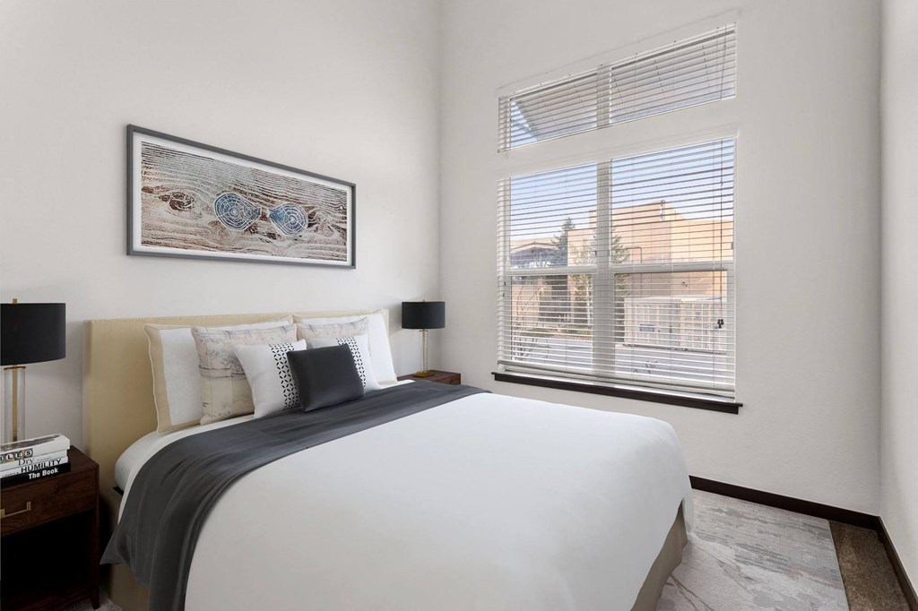 a bedroom with a large bed and a large window