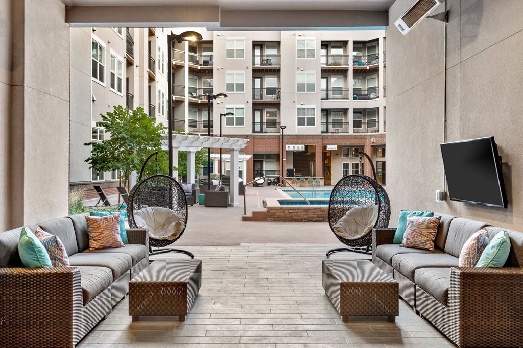 a lobby with couches and chairs and a tv