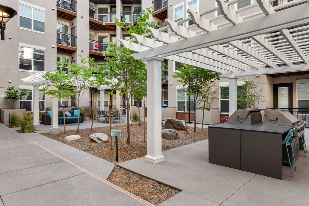 an open courtyard with a bar and a kitchen in an apartment building