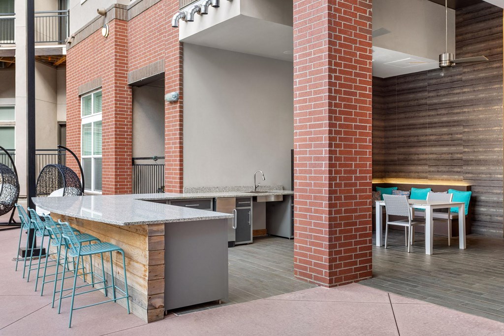 a bar and dining area in a building with chairs and tables