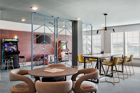 a dining room with a table and chairs and a video game
