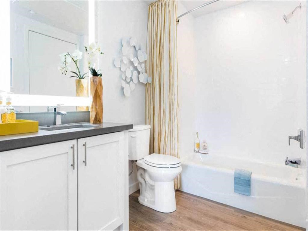 a bathroom with a toilet and a tub and a sink