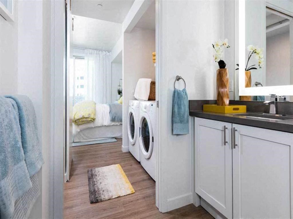 a small laundry room with a sink and a washing machine