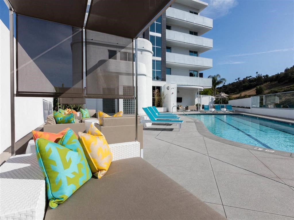 a view of a swimming pool from a balcony with pillows