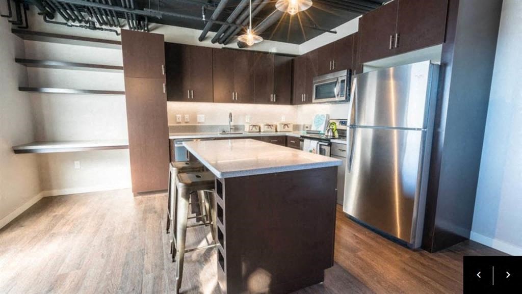 kitchen with wood-style flooring in specific apartments