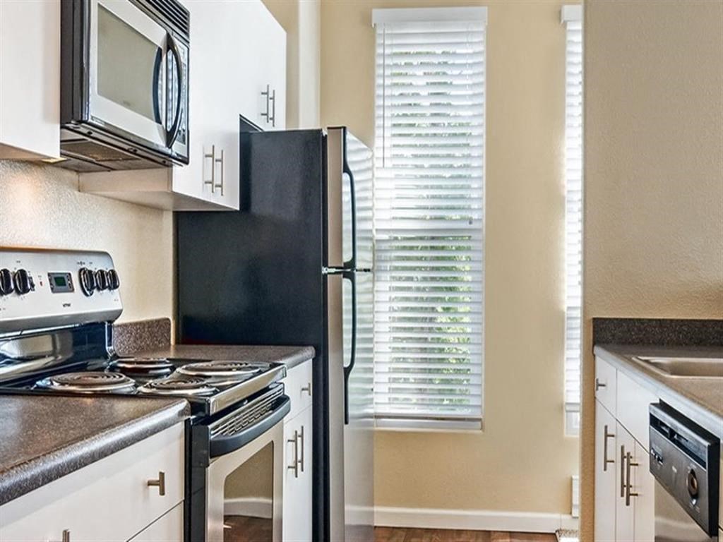 a kitchen with a stove and a refrigerator