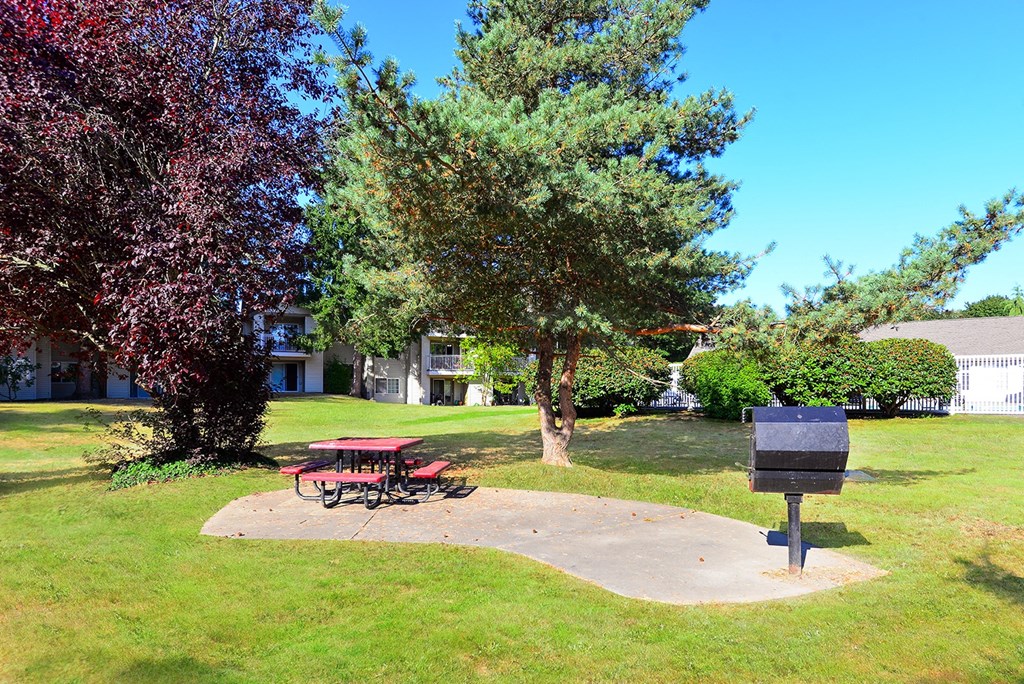 a picnic table and a mailbox in a park