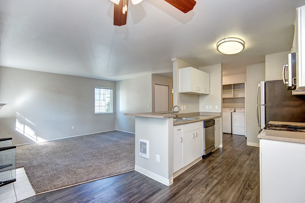 an empty kitchen and living room with an open floor plan