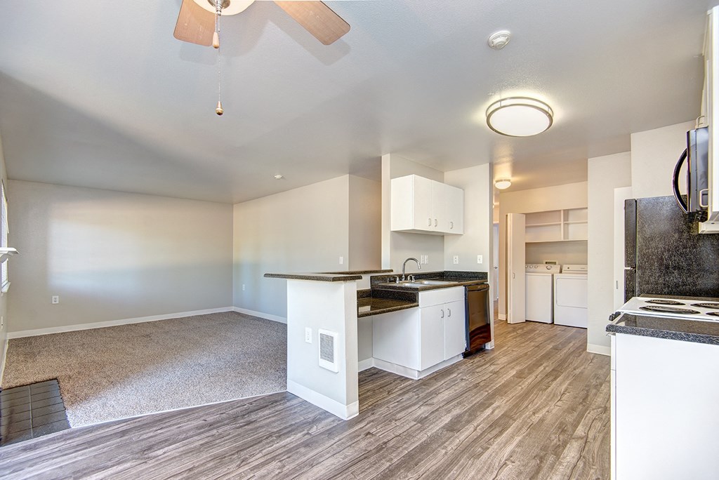 a kitchen and living room with an open floor plan