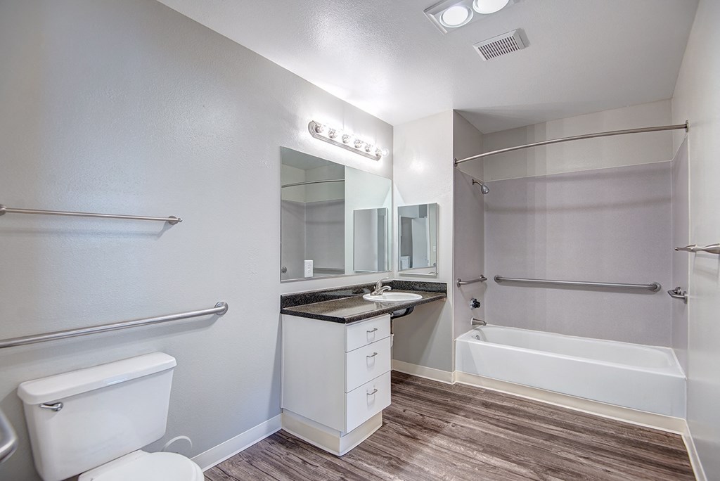 an empty bathroom with a toilet and a sink and a shower