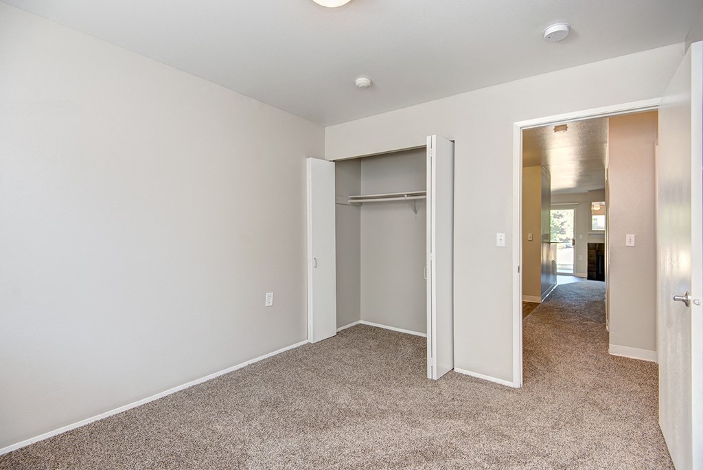 a bedroom with a closet and a hallway with an open door