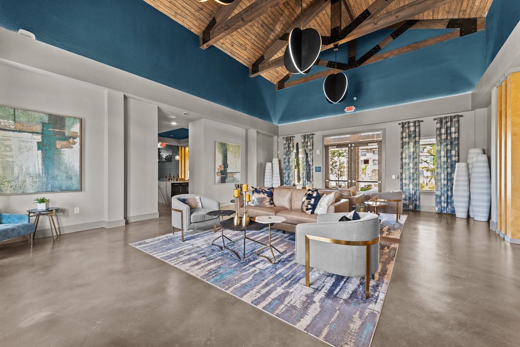 a living room with couches and chairs and a rug