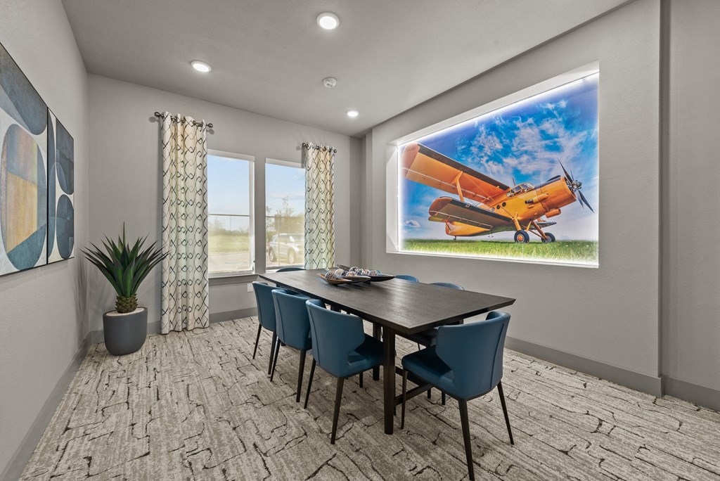 the retreat dining room with table and chairs and a painting of an airplane