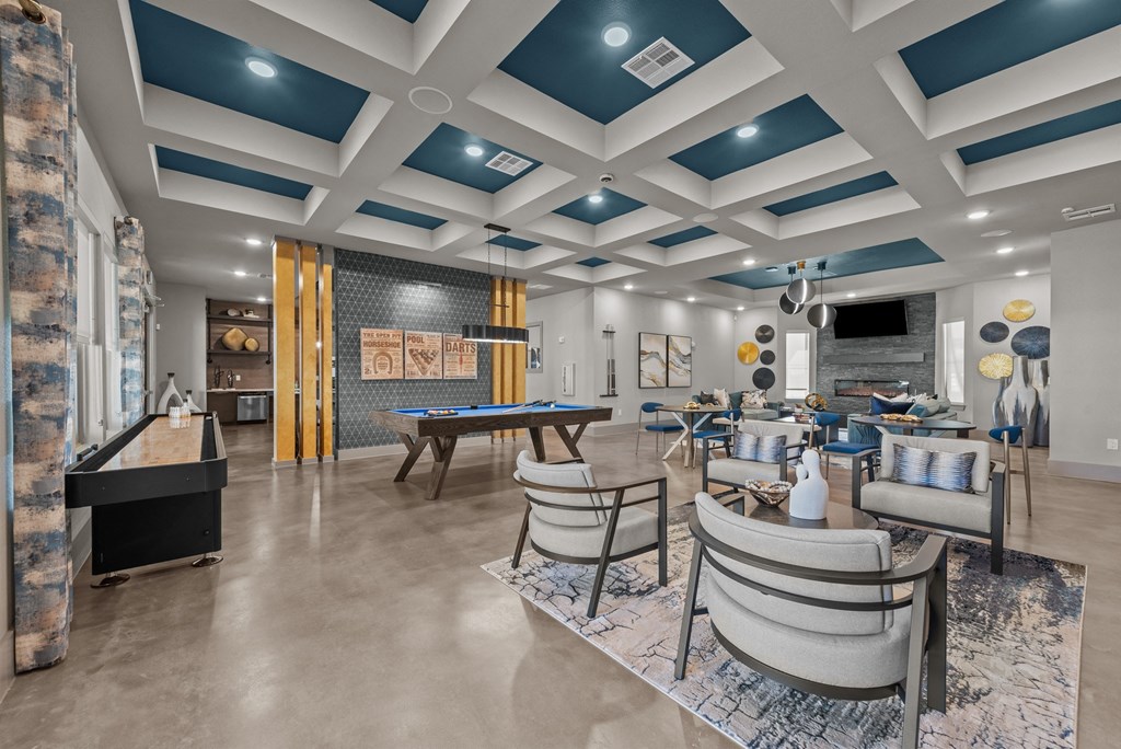 a clubhouse with tables and chairs and a pool table