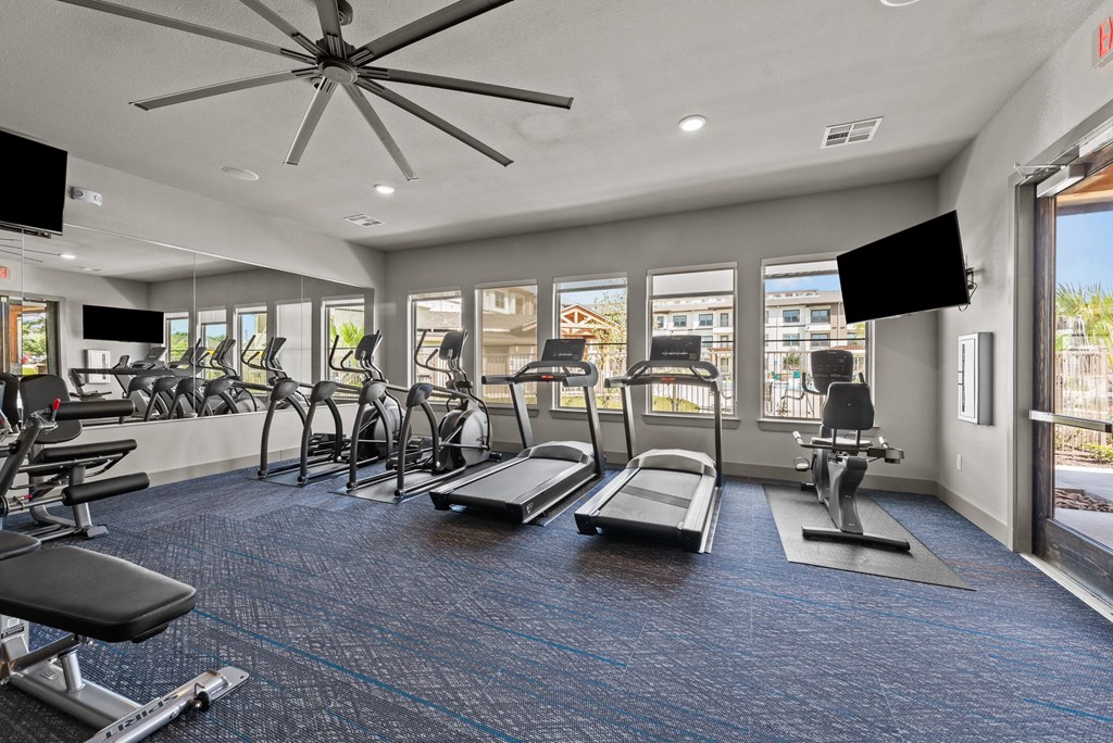 our state of the art fitness center with cardio equipment and windows at our