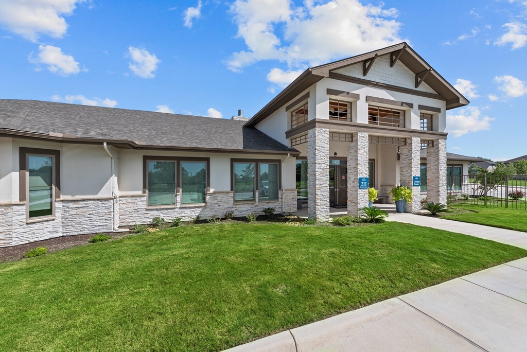 a house with a lawn and a sidewalk in front of it
