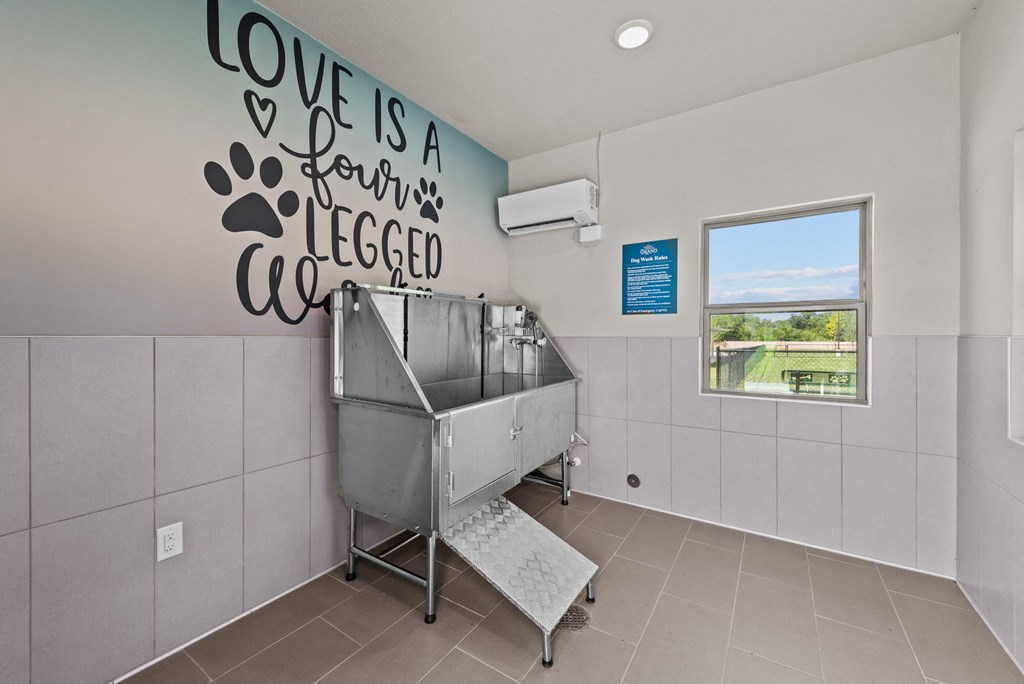 a sink in a room with a wall saying love is a ferris wheel