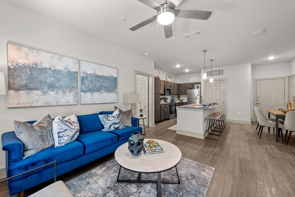 a living room with a blue couch and a table