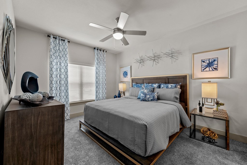 a bedroom with a bed and a ceiling fan