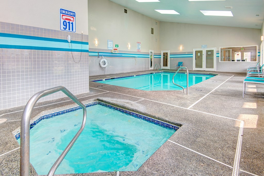 a swimming pool and spa in a hotel room