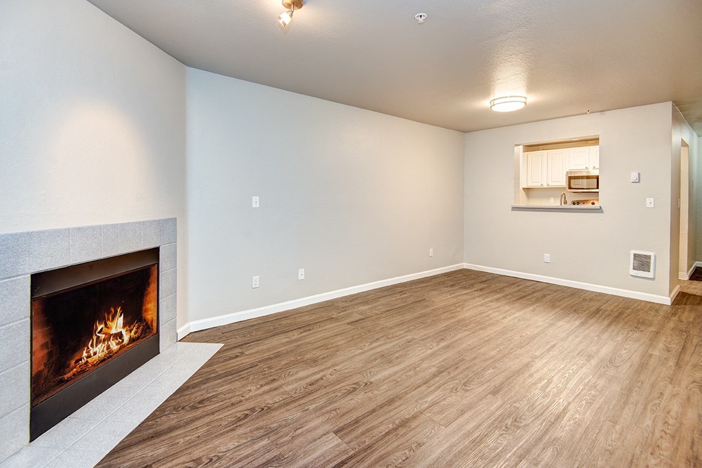 a living room with a fireplace and a wooden floor