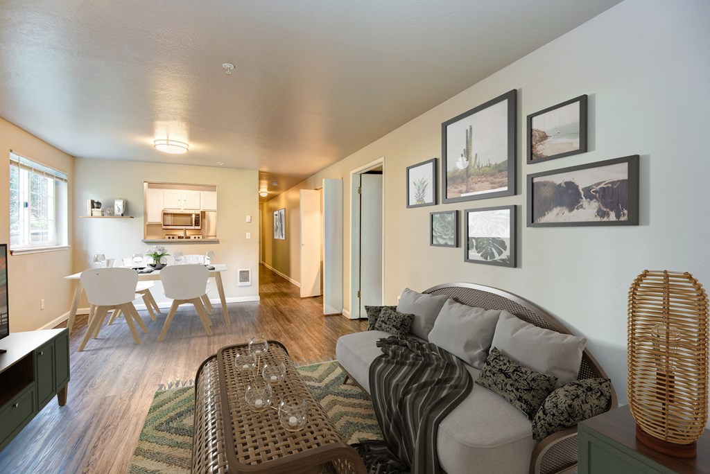 a living room with a couch and a chair and a dining room and a kitchen