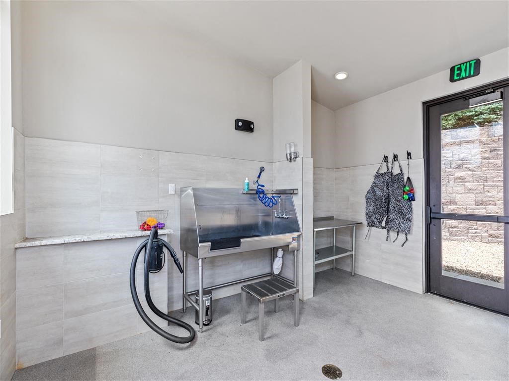 a laundry room with a sink and a door