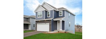 A two-story house with a garage on the first floor and a front porch on the second.