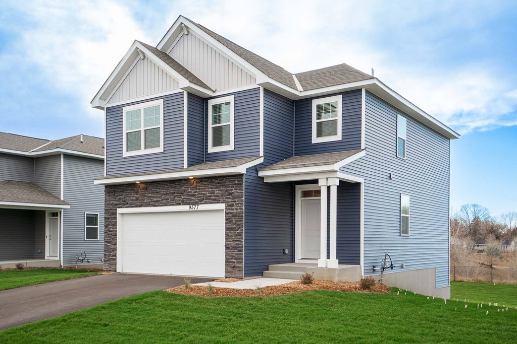a blue house with a white garage door