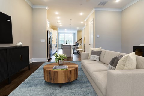 A living room with a white couch and a wooden coffee table.