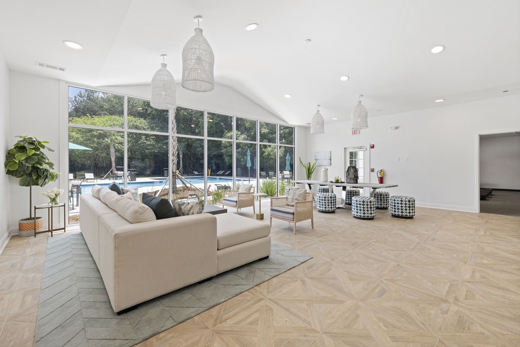a living room with a large window and a view of a pool